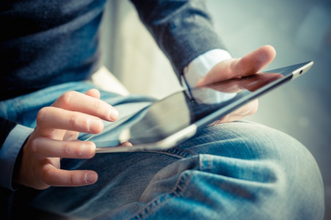 close up hands multitasking man using tablet, laptop and