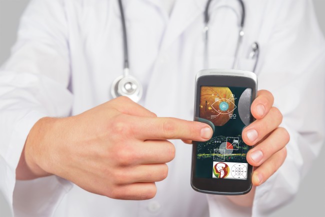 Man doctor is pointing on mobile phone space for text 